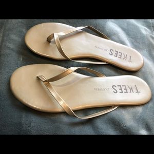 TKEE flip flops in gold